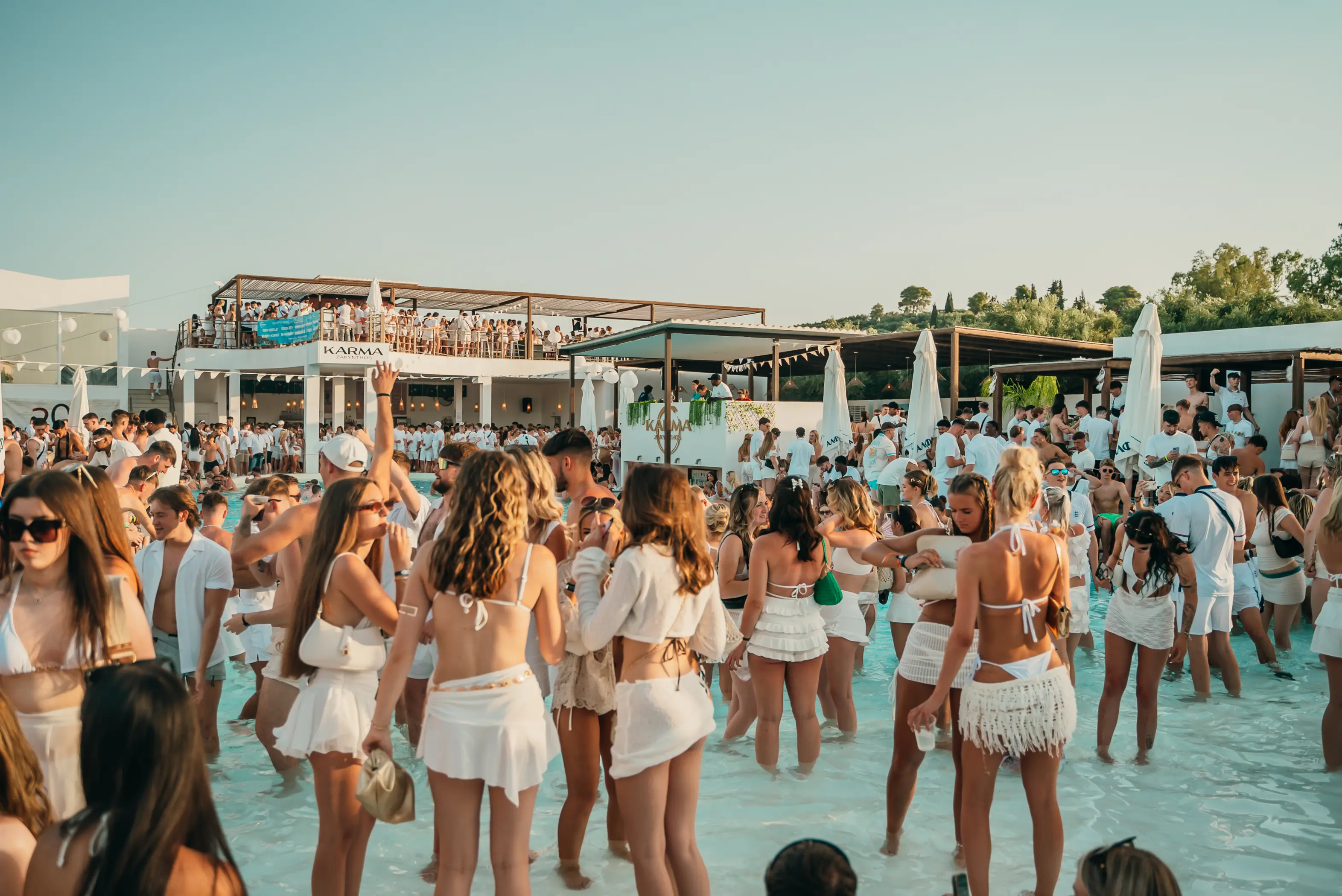 A packed White Party beneath the evening sky in Zante